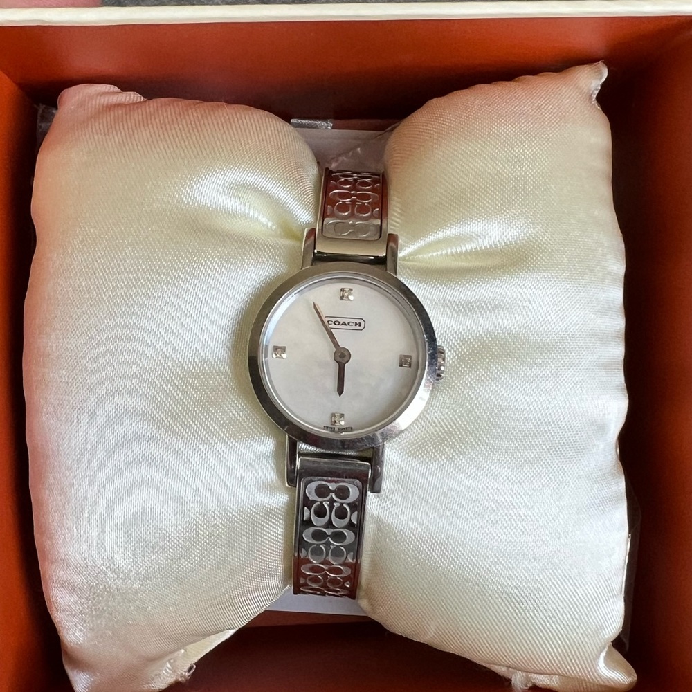 Coach women’s mini band watch.